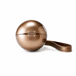 Detailed close-up of spherical bronze acrylic evening clutch with gold rivet hinges