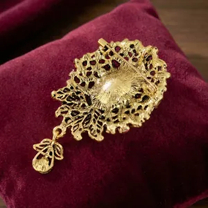Back view of vintage Baroque gold brooch showing pin detail and hollow metalwork