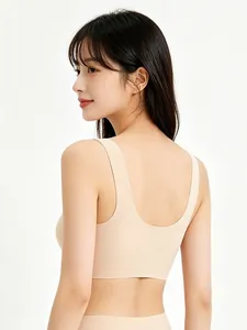 Detail of seamless beige U-back bra showing smooth skin-friendly fabric on a model
