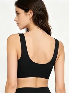 Detail of black seamless U-back sports bra with wide shoulder straps and elastic fabric