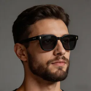 Close-up of retro black square sunglasses featuring distinct gold star rivets on the frame