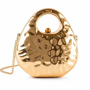 Golden hammer-textured egg-shaped evening clutch bag with circular handle and chain strap