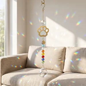 Rainbow crystal suncatcher with golden paw and heart charms reflecting light