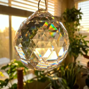 Close-up of a faceted K9 crystal ball suncatcher showing vibrant rainbow light refraction