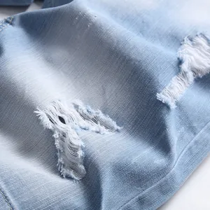Light blue washed denim jeans featuring distressed ripped details and twill cotton texture
