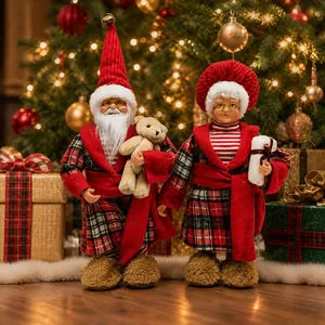 Detail of standing Santa and Mrs. Claus figures in red plaid outfits for Christmas decor