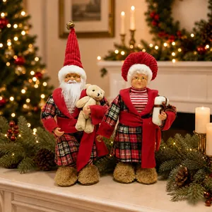 Detailed Christmas couple figurines in red plaid outfits within a cozy holiday setting