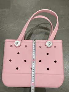 Detail of pink EVA beach tote showing 22cm height with tape measure and side texture