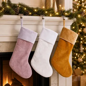 Three plush Christmas stockings in lilac, white, and ginger hanging on a white fireplace
