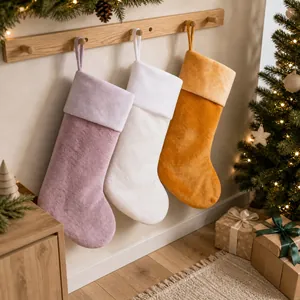 Detailed view of plush Christmas stockings in pink, white, and yellow hanging on tree
