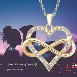 Golden infinity heart pendant necklace with shimmering zircons on romantic couple background