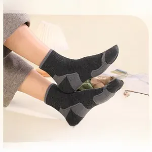 Detail of thick merino wool hiking socks with cushioned towel sole for winter warmth