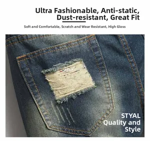 Macro shot of distressed back pocket detail on men's vintage washed blue straight denim jeans