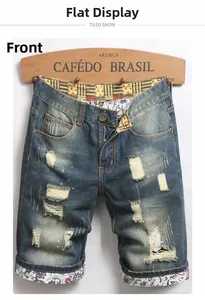 Detail of distressed denim shorts featuring ethnic pattern patchwork and ripped texture