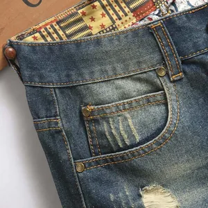 Men's distressed straight jeans in deep blue with star-patterned inner lining and ripped details