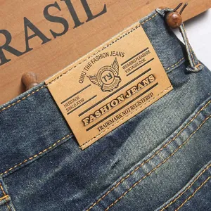 Men's vintage distressed straight denim jeans with whisker wash and leather back patch
