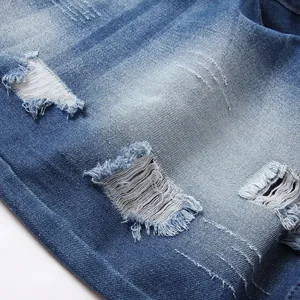 Slim fit ripped denim shorts for men with distressed holes and washed blue texture