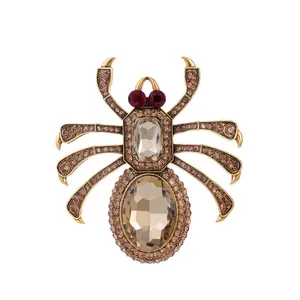Detailed macro view of vintage spider brooch with champagne rhinestones and red gem eyes