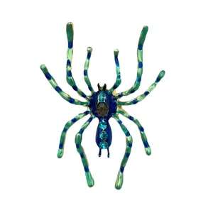 Detailed view of blue and green enamel spider brooch with sparkling rhinestones