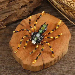 Detailed macro view of a spider brooch featuring green crystals and opal on wood