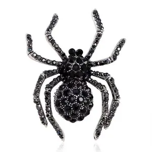 Macro shot of spider-shaped brooch with black pavé crystals and silver metal finish