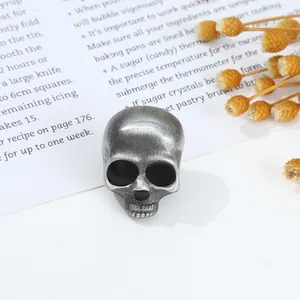 Macro shot of skull ring with vintage silver finish on recipe paper background