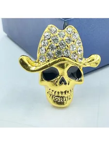 Sparkling skull cowboy hat brooch with clear rhinestones and golden alloy finish