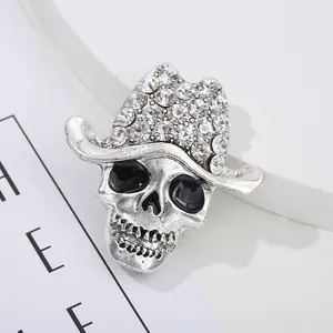Vintage silver skull brooch wearing a sparkling rhinestone cowboy hat in punk dark style
