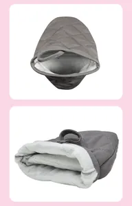 Detail of dark grey quilted cotton oven mitt showing thick white fleece lining and hanging loop