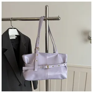 Macro detail of lavender faux leather shoulder bag with metallic buckle strap and eyelets