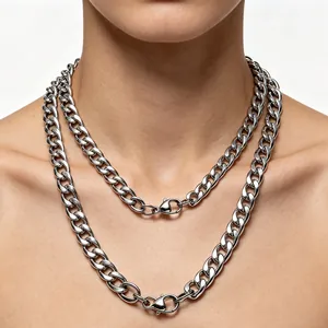 Close-up of layered silver titanium steel Cuban link necklaces with sturdy lobster clasps