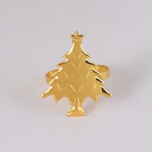 Detailed view of a gold Christmas tree napkin ring with layered texture and star topper