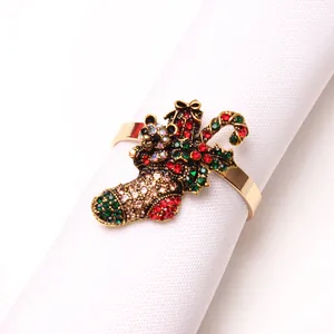 Macro shot of gold metal Christmas stocking napkin ring with festive colorful rhinestones