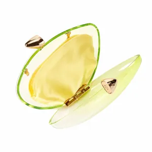 Detail of neon green gradient acrylic clutch with golden bullet magnetic clasps