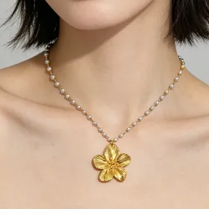 Golden five-petal flower pendant necklace with white pearl chain and textured petals