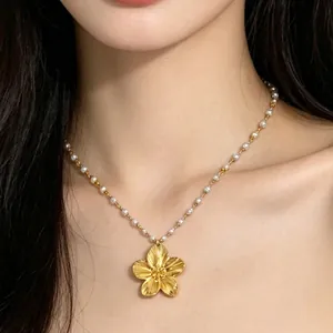 18K gold plated flower pendant necklace with white pearl chain on model neck