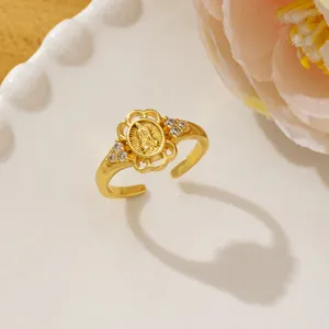 Macro detail of gold Virgin Mary ring featuring pave cubic zirconia and open band