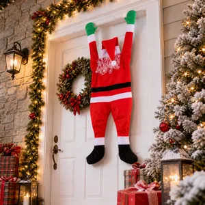 Velvet Santa Claus climbing wall decoration hanging on a white front door for Christmas