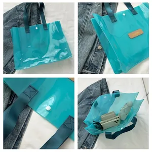 Detail of transparent green tote bag showing snap button and internal storage space