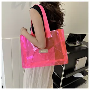 Detail of pink transparent PVC tote bag with canvas straps and leather brand tag