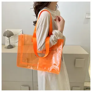 Detailed shot of an orange transparent PVC tote bag with MS. HUIXIBAG leather patch