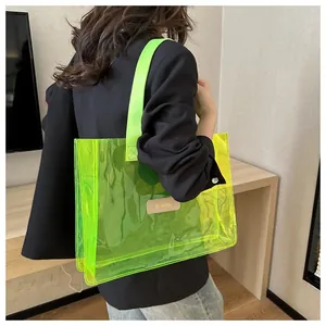 Neon green transparent tote bag with MS. HUIXIBAG leather patch on black suit jacket