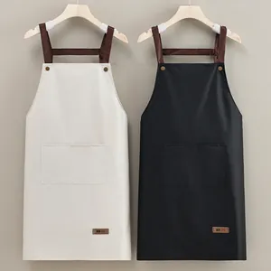 Waterproof kitchen apron with H-shaped wide straps and large front pocket in black and white