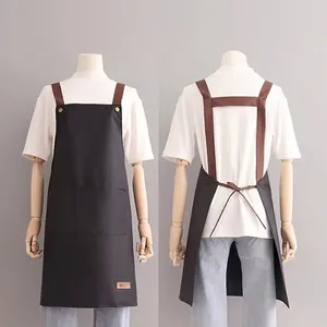Waterproof kitchen apron with cross-back straps and front pocket shown from front and back