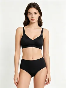 Detail of a black seamless wire-free bra set with high-waisted shorts on a model