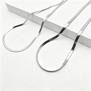 Detail of silver flat snake chain necklaces in 3mm and 5mm width on white display