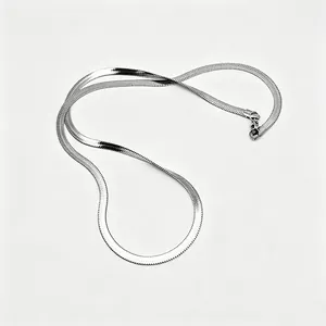 Close-up of silver herringbone chain necklace showing smooth texture and lobster clasp