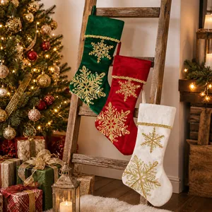 Three-piece velvet Christmas stocking set with gold snowflake embroidery and hanging loops