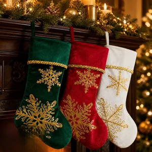 Detail of velvet Christmas stockings with gold snowflake embroidery by a fireplace