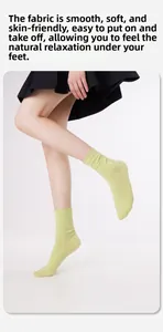 Dettaglio di calze in cotone verde chiaro indossate da modella con gonna a pieghe nera